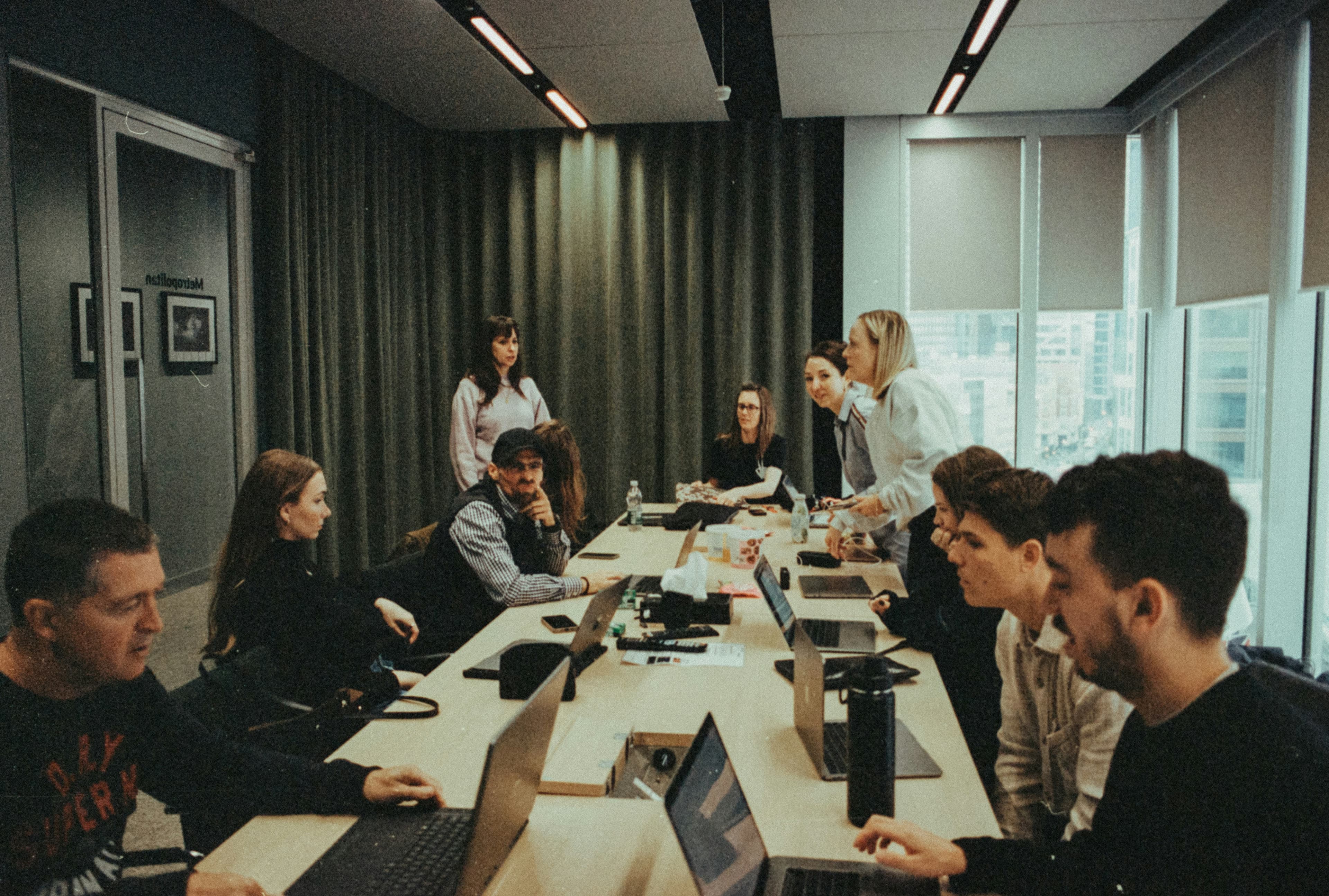 A group of professionals in discussion around a conference table